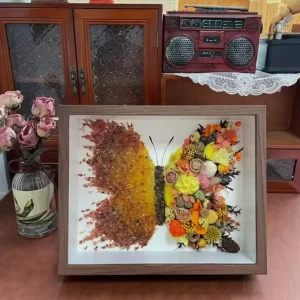 Close-up of Pemelo yellow Crystal crystals and pressed flowers in butterfly shadow box